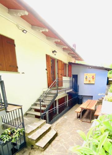 a building with stairs and a bench and a table at PTHouse in Badia Prataglia