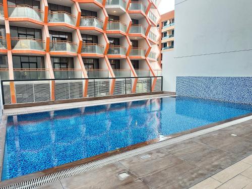 a swimming pool in front of a building at Sleek 1BR in DSO, Dubai in Dubai