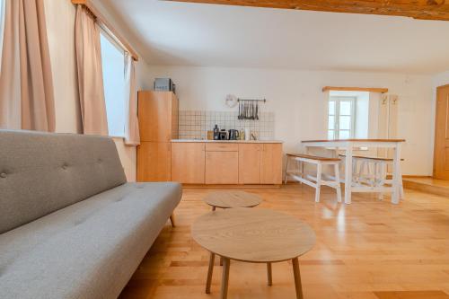 a living room with a couch and a table at Whats-App Self-Check-IN - Bad Aussee City House in Bad Aussee