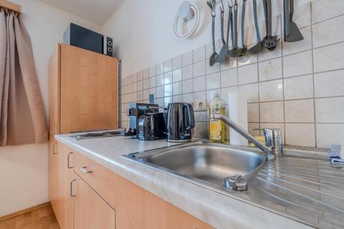 a kitchen with a stainless steel kitchen sink at Whats-App Self-Check-IN - Bad Aussee City House in Bad Aussee