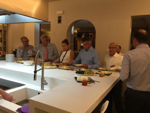 a group of people sitting around a counter eating food at Albergo Al Cacciatore Tortellinando in Valeggio sul Mincio