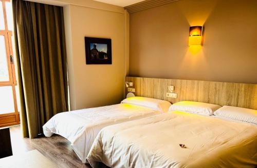 a bedroom with two beds in a room at Hotel Gran Casona de Sanabria in Puebla de Sanabria