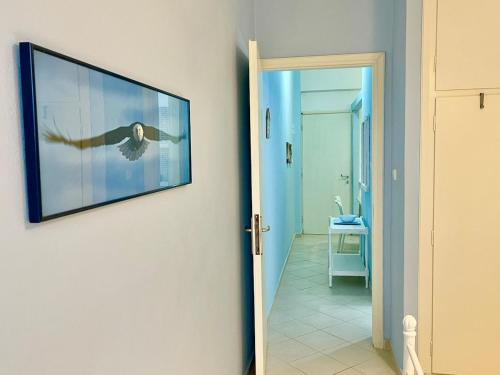 a picture hanging on a wall in a hallway at BLE, Oneiropagida, Aegina in Vathí