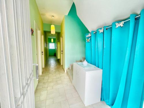 a bathroom with blue and green walls and a toilet at BLE, Oneiropagida, Aegina in Vathí