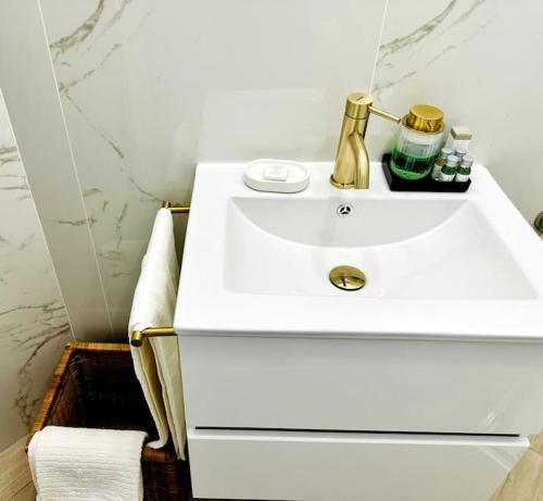 a white bathroom with a white sink in a room at La Piccola Luxury Suite in Rome