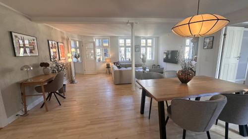 a dining room and living room with a table and chairs at Løvstræde apartments from 1 to 6 in Copenhagen