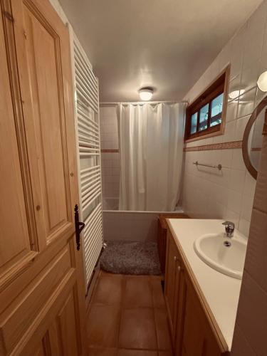 une salle de bain avec un lavabo et une baignoire dans l'établissement Charmant appartement avec jardin et magnifique vue, à Saint-Jean-de-Sixt