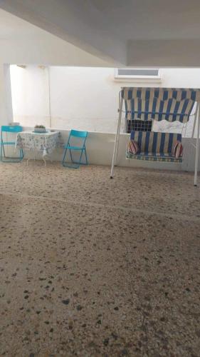 a room with a bed and two chairs and a table at Villa by the Sea, Nyfida Lesvos in Nifida