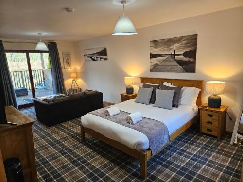 a bedroom with a bed and a living room at Letterfinlay Lodge House in Letterfinlay