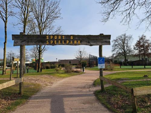 a sign for a park with a sign for a trail at Boshuisje op de Schatberg in Sevenum