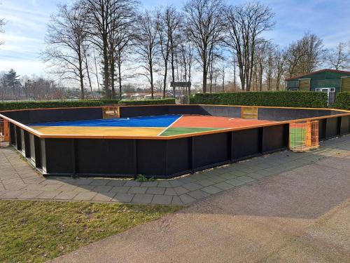 a ramp with a trampoline in a park at Boshuisje op de Schatberg in Sevenum
