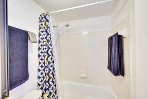 a bathroom with a white tub and a shower at Daytona Beach Condo with Ocean-View Balcony! in Daytona Beach