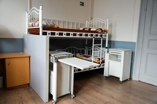 a bunk bed in a room with a desk and a bunk bed at YOUR HOSTEL midi station in Brussels