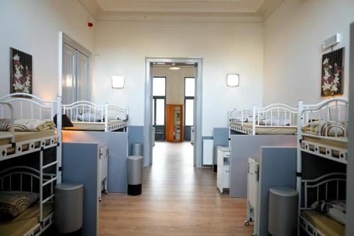 a room with several bunk beds and a hallway at YOUR HOSTEL midi station in Brussels