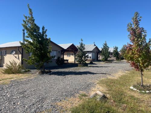a row of houses on a gravel road at Cabañas Campestres Inés in Chillán