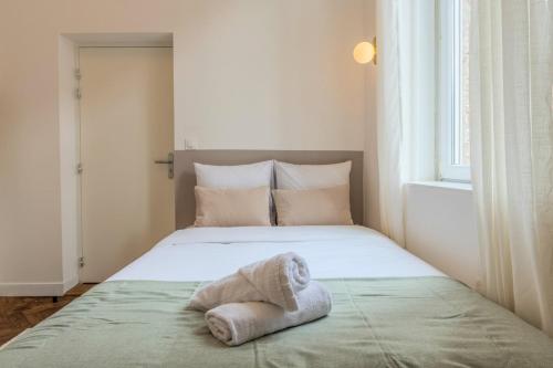 une chambre avec un lit avec une serviette dessus dans l'établissement Studio fonctionnel pour une personne, proche tram, à Tourcoing