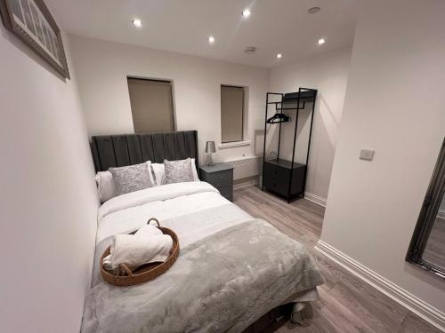 a bedroom with a large bed with a basket on it at Apartment 2 The Baileys Cwm Sleeps 2 in Cwm