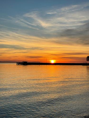 a sunset over a large body of water at SeeHotel Amtshof in Langenargen