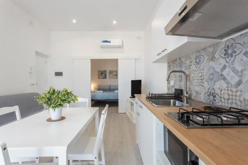 a kitchen with a sink and a counter top at Casa Ludovica in Isola delle Femmine