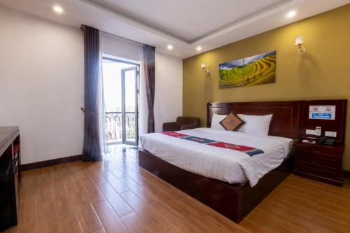 a hotel room with a bed and a large window at Melody Sapa in Sa Pa