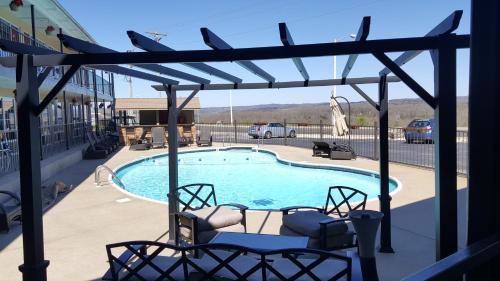 a patio with two chairs and a swimming pool at The Park at Foxborough in Branson