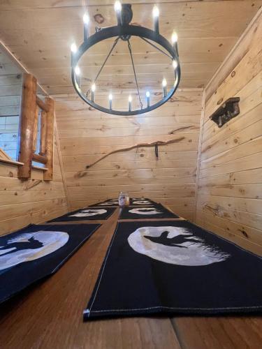 a room with a chandelier in a log cabin at Cabin in the treetops! in Lancaster