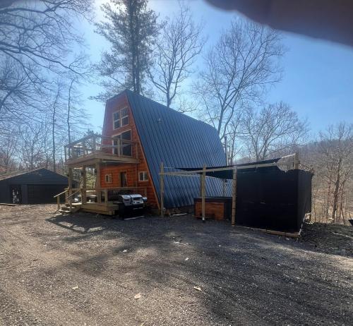 a barn with a metal roof on top of it at Cabin in the treetops! in Lancaster