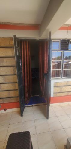 a room with a bunk bed and a window at Premier BnB in Meru