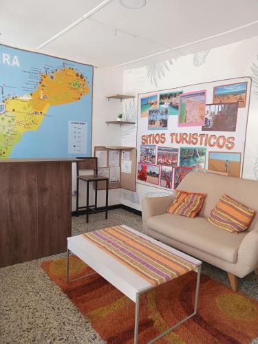 a living room with a couch and a large screen at Hostel SOLUNA Operador Turístico y Hotelero in Ríohacha
