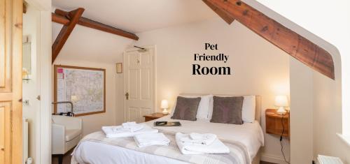 a bedroom with a bed with two towels on it at The Royal Oak in Gillamoor