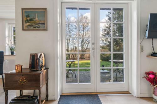 a room with a door leading to a patio at Lovely Holiday Home Near Gudhjem in Gudhjem