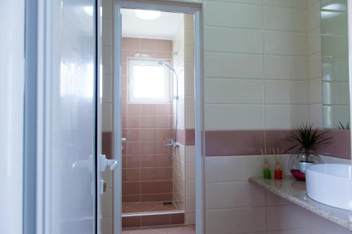 a bathroom with a shower with a glass door at Guest House Pasha in Ulcinj
