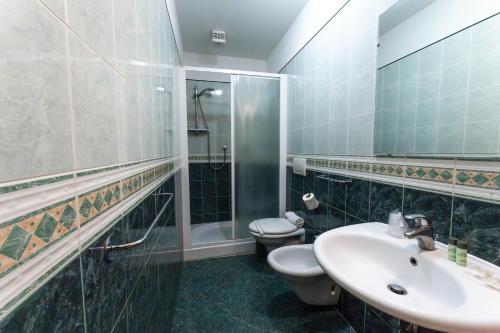 a bathroom with a sink and a toilet at Residence Marconi Mare in Rimini