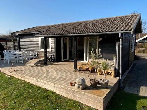 a wooden deck in front of a house at Lovely House With Sea View And Large Terrace in Karrebæksminde