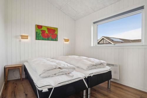 two beds in a room with a window at Lovely Holiday Home In Southern Jutland in Neder Lysabild