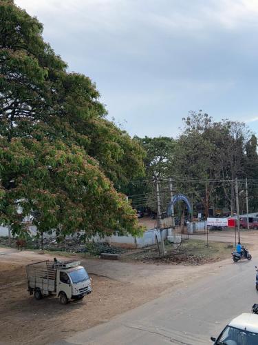 a white truck parked on the side of a road at Sujith Comforts in Hullahalli
