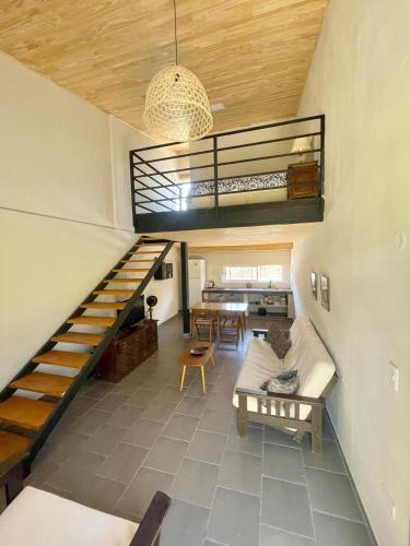 a living room with a staircase and a table at Loft Jujuy 2 Departamento Céntrico in San Salvador de Jujuy