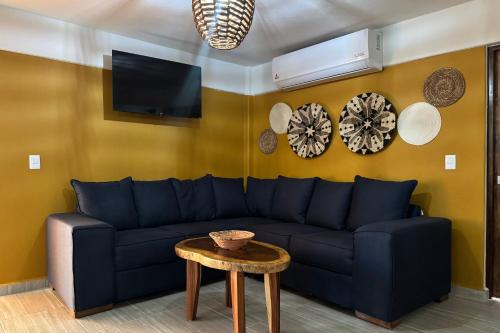 a living room with a blue couch and a table at Ixic posada boutique in Zihuatanejo