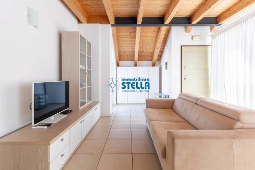 a living room with a couch and a tv at Residence Adriatica in Lido di Jesolo
