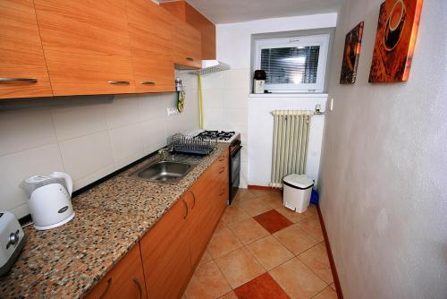 a small kitchen with a sink and a stove at Privat Kohut in Štrba