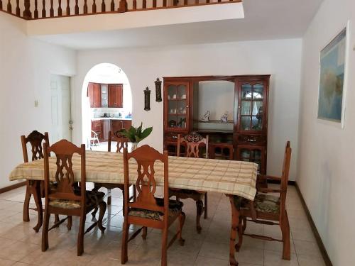 a dining room with a table and chairs at Maranatha Close in Montego Bay