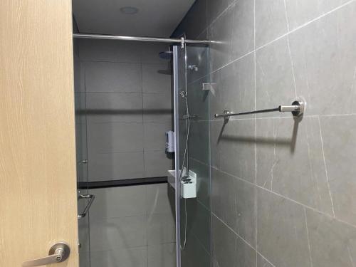 a shower with a glass door in a bathroom at Homestay Dragon Castle Bãi Cháy Hạ Long Quảng Ninh in Ha Long
