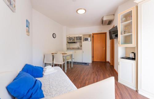 a living room with a couch and a table at Residence Marconi Mare in Rimini
