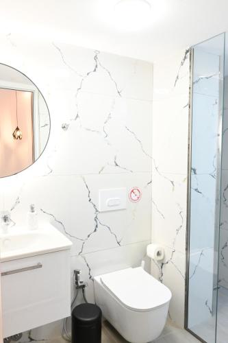 a bathroom with a toilet and a sink at Vila La Familia in Ksamil