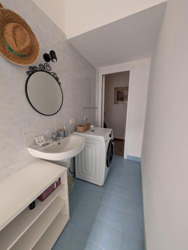 a bathroom with a sink and a washing machine at Hbhall Residenze Darsena in Milan