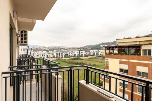 an apartment balcony with a view of a city at Tirent Apartment-Modern Bedrooms Stay Near Liqeni i Thatë in Tirana