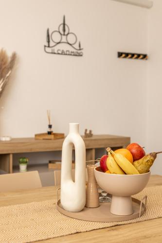 a table with a bowl of fruit and a juicer at Il Cammino in San Quirico dʼOrcia