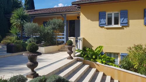 a house with three vases with plants in front of it at Casa Méline - Disneyland Paris in Montry