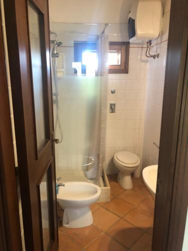 a bathroom with a toilet and a sink at Baglio Marotta in Valderice