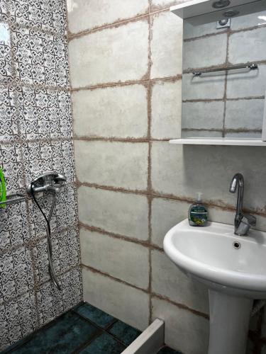 a bathroom with a sink and a shower at Kantouni house Chios in Pyrgi
